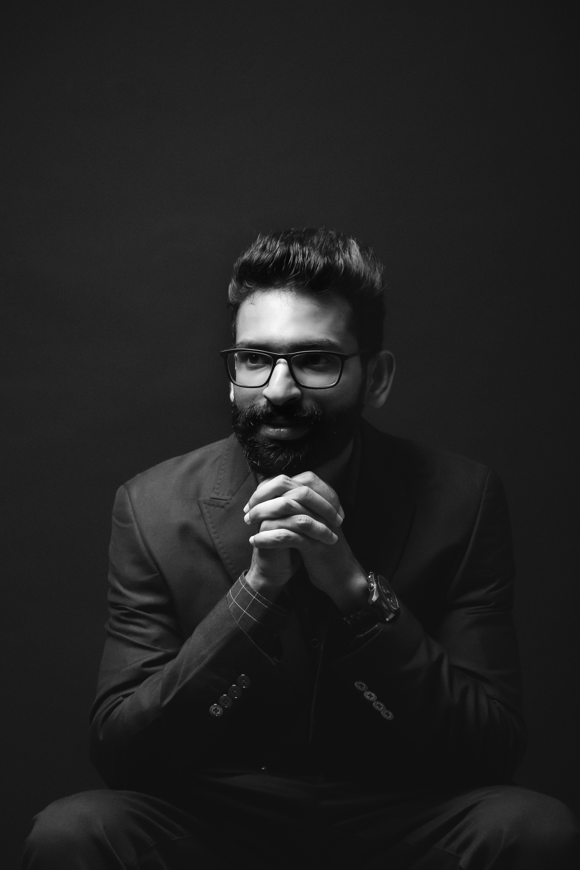 Grayscale Photo of a Bearded Man in Black Suit Wearing Eyeglasses